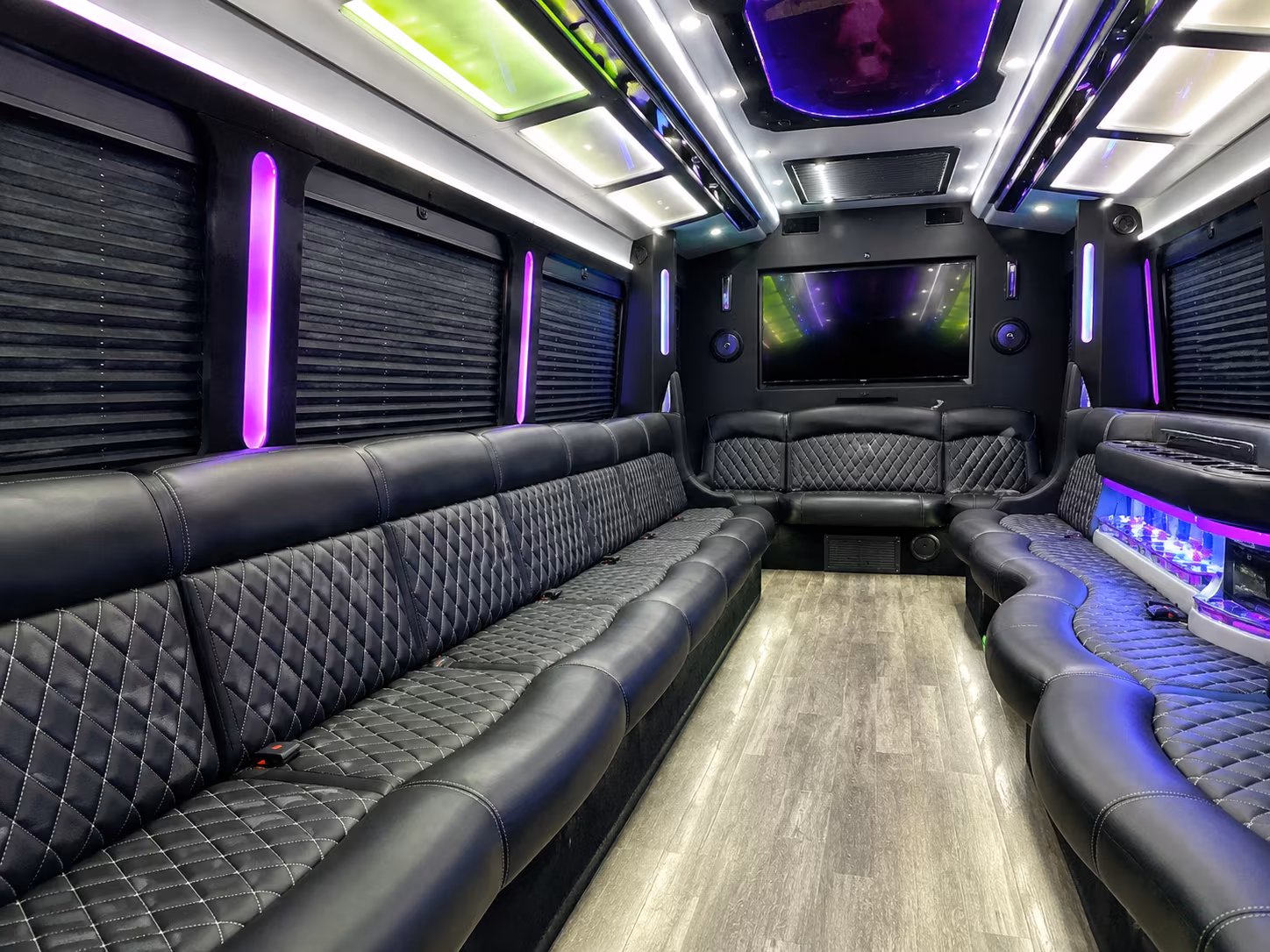 Friends laughing during a party bus celebration in Chandler